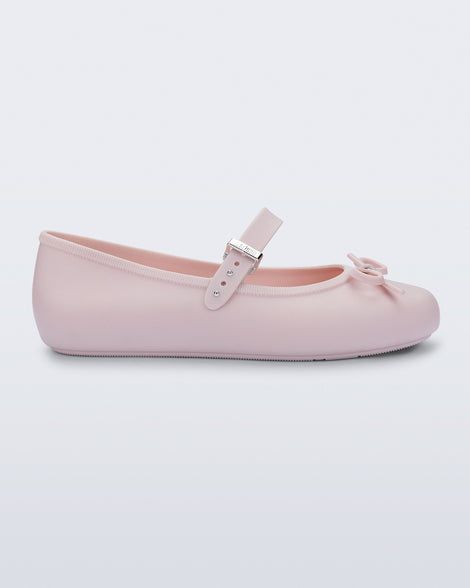 Side view of a pink Soft Ballerina Delicate Bow flat with top strap and bow
