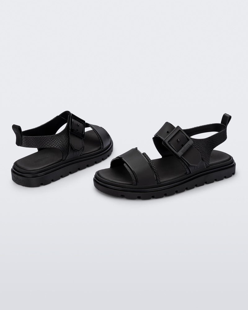 Angled view of a pair of black Connection Papete sandals