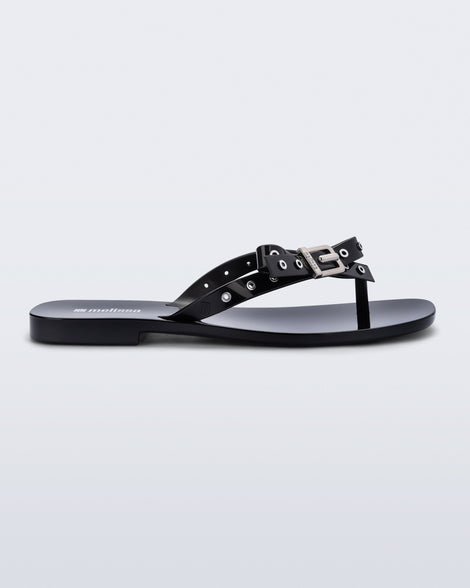 Side view of a black Harmonic Squared flip flop with bow on strap