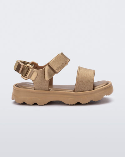 Side view of a gold baby Kick Off Sandal