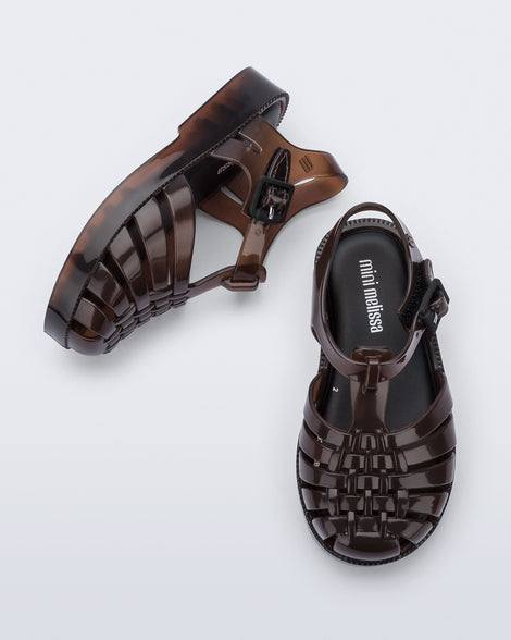 Side and top view of a pair of clear brown Possession baby sandals