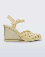 Side view of a creamy yellow Agata wedge heel sandal with ankle strap