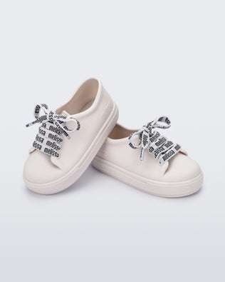 Top and side view of a pair of white baby Hip M Lover sneakers with laces