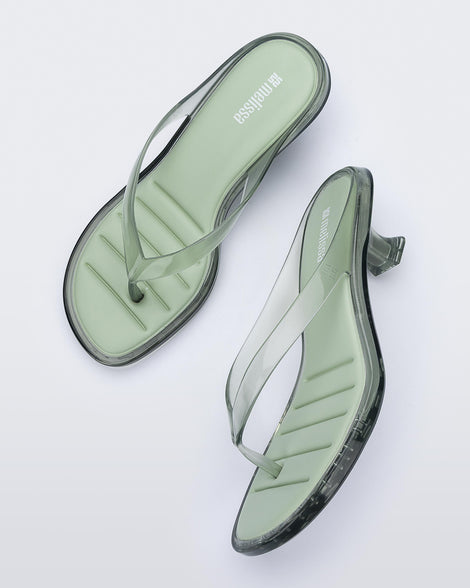 Top and side view of a pair of transparent green Flip Flop Kitten Heels