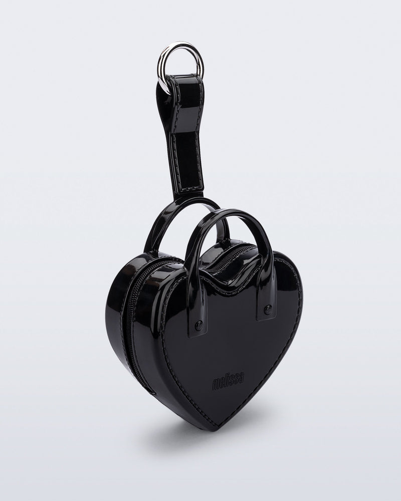 Angled view of a black Heartbeat Pocket bag charm