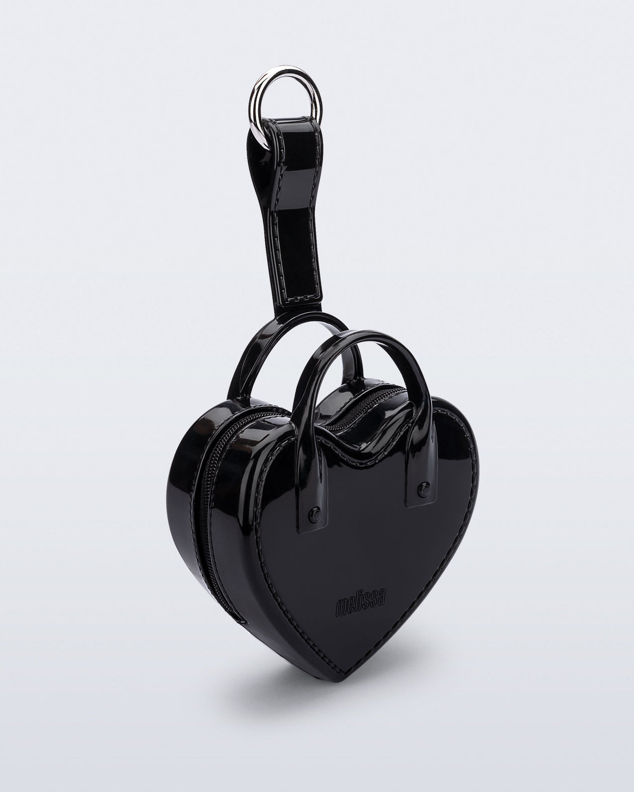 Angled view of a black Heartbeat Pocket bag charm