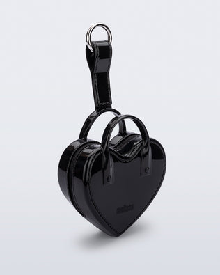 Angled view of a black Heartbeat Pocket bag charm
