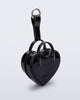 Angled view of a black Heartbeat Pocket bag charm