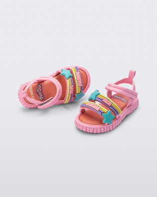 Top and angled view of a pair of pink Create + Play Doh sandal with rainbow and star straps