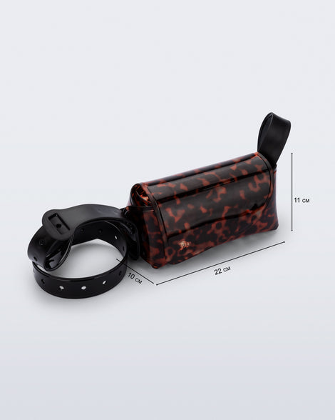 Angled view of a tortoise Cross Bag with adjustable black strap and bag measurements of 22cm x 10xm x 11cm