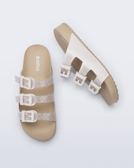Top and side view of a pair of beige Cozy Stripes sandals with white upper with 3 buckles