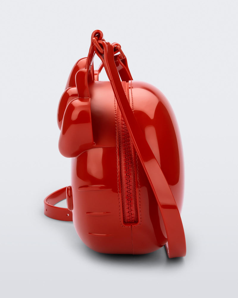 Side view of a red Hello Kitty + Friends Cute Bag with the face of Hello Kitty