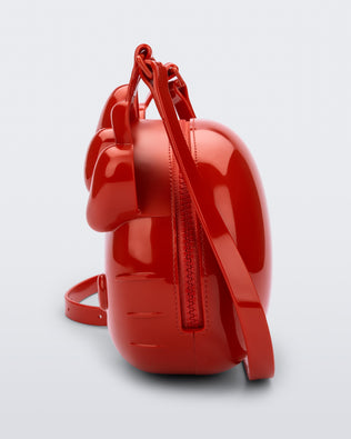 Side view of a red Hello Kitty + Friends Cute Bag with the face of Hello Kitty