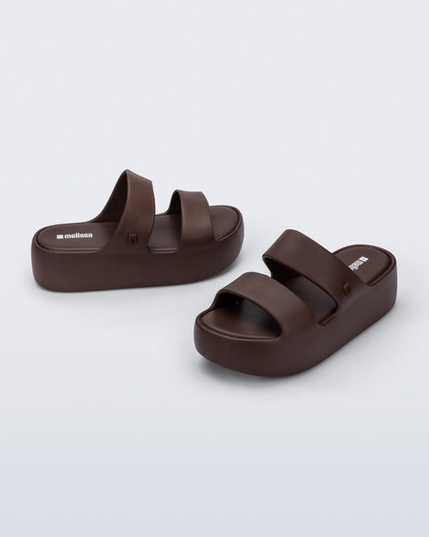Angled and side view of a pair of brown Free Line Platform slides
