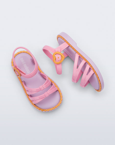 Side and Top view of a pair of pink Aurora baby sandals with purple sole and orange trim and buckle