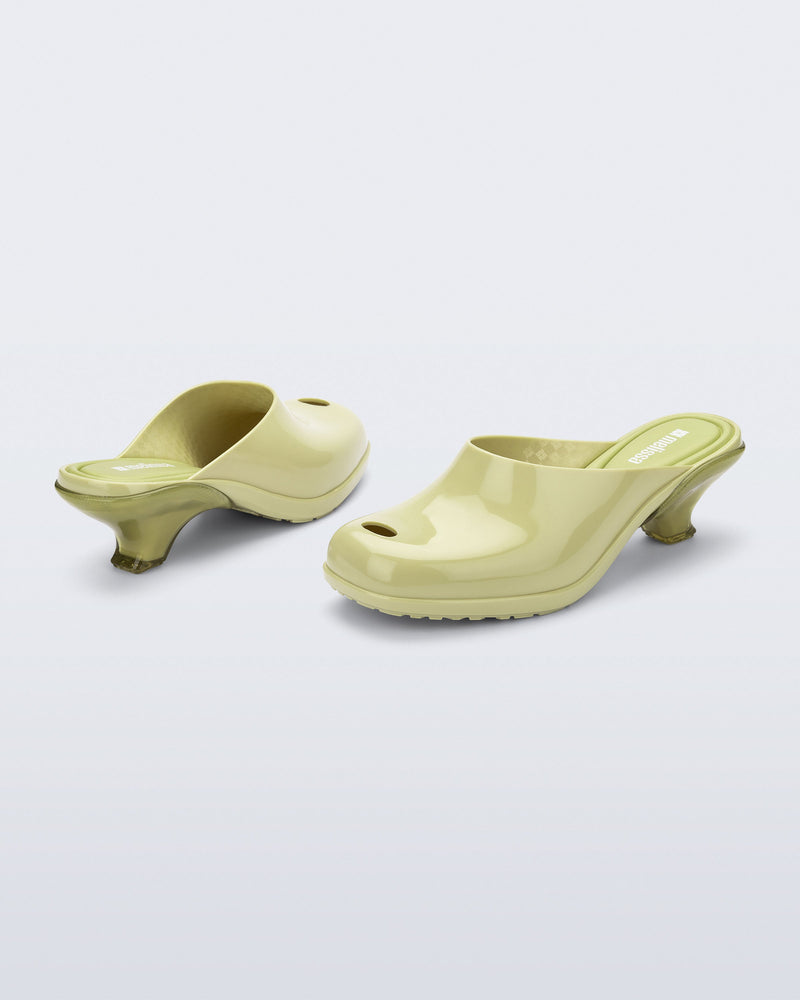Back and angled view of a pair of green Gaia kitten heels with peep toe
