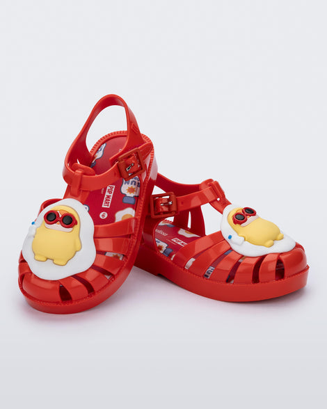 Angled view of a pair of red Possession + Pop Mart Pucky fisherman baby sandals