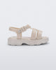 Side view of a beige Ella baby sandal with ankle strap