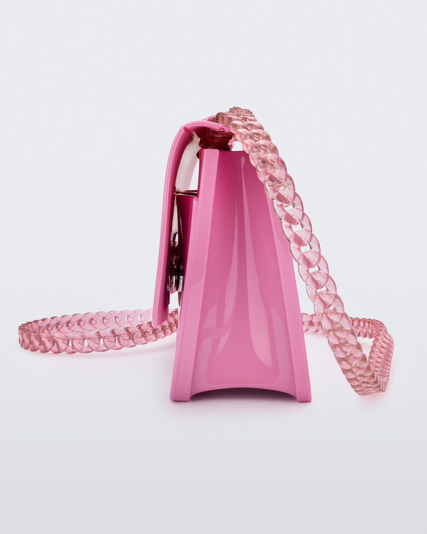 Side view of the Melissa party handbag in pink with braided strap.
