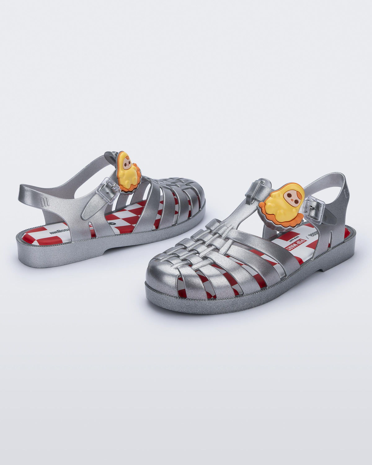 Back and angled view of a pair of silver Possession + Pop Mart Pucky fisherman sandals
