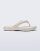 Side view of a beige Free Low flip flop