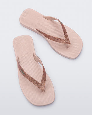 Top view of a pair of pink with pink glitter strap Sun Long Beach flip flop