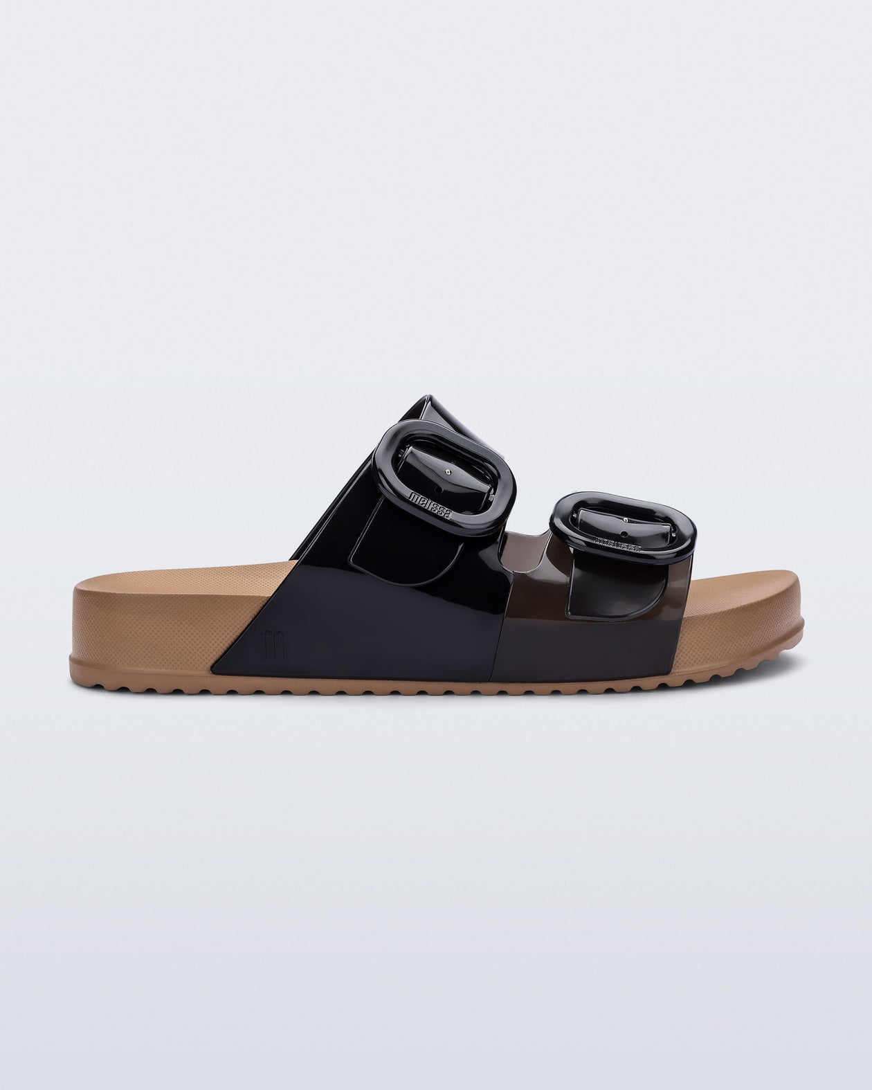 Side view of a black Cozy slide with beige sole