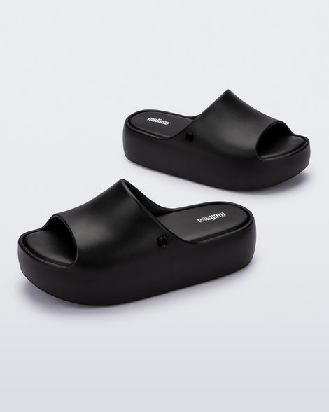 Angled view of a pair of black Free Platform women's slides