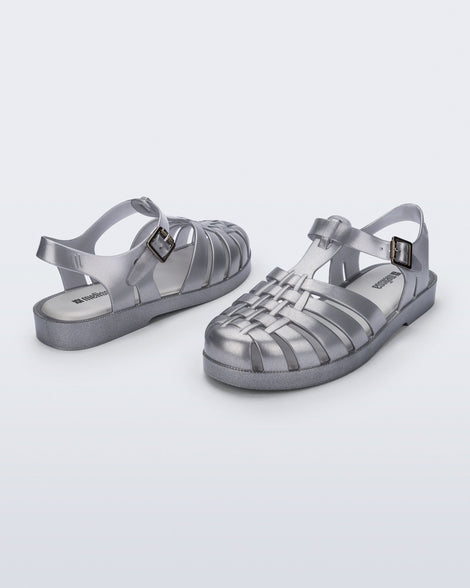 Back and side angled view of a pair of magic silver Possession Fisherman sandals