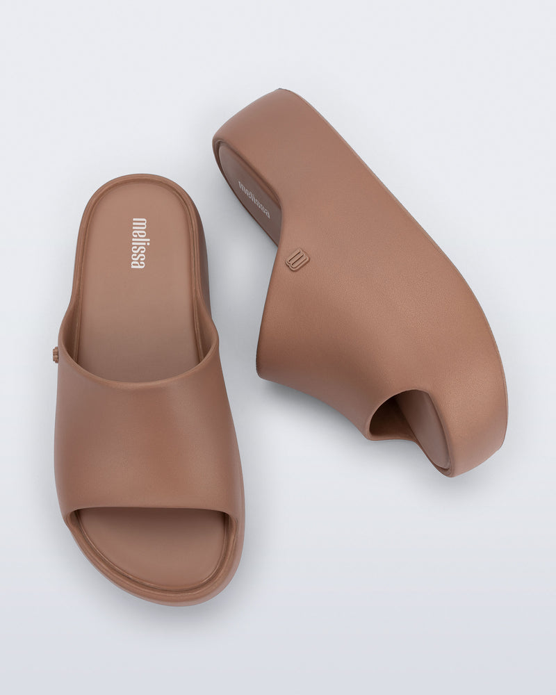 Side and top view of a pair of brown Free Platform Slide sandals