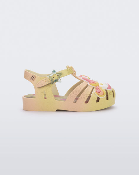 Side view of a yellow/pink Possession Unicorn baby sandal with unicorn on front upper