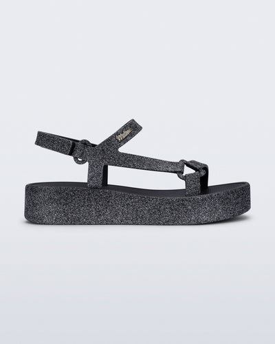 Side view of a black glitter Sun Downtown Platform sandal