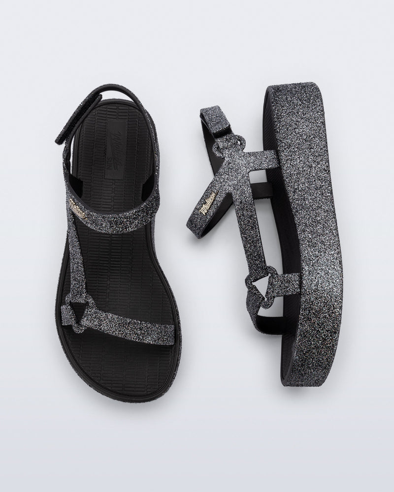Top and side view of a pair of black glitter Sun Downtown Platform sandals