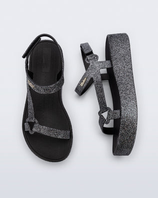 Top and side view of a pair of black glitter Sun Downtown Platform sandals