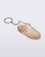 Angled view of glitter beige Possession keyring