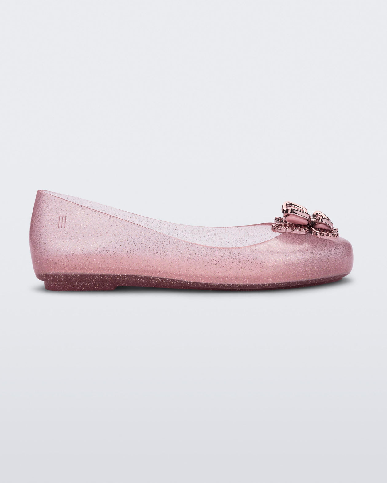 Side view of a glitter pink Mini Melissa Sweet Love Butterfly flat with a pink butterfly detail on the toe