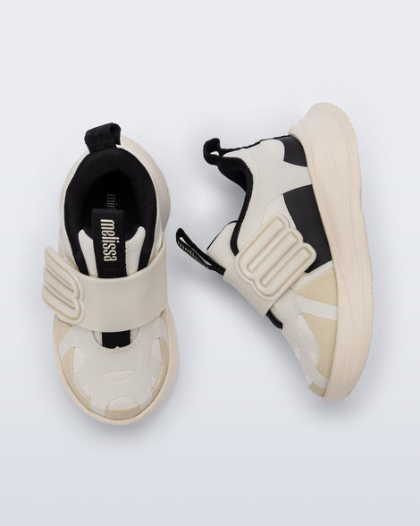 Side and top view of a pair of off white X Beat baby sneakers with black trim
