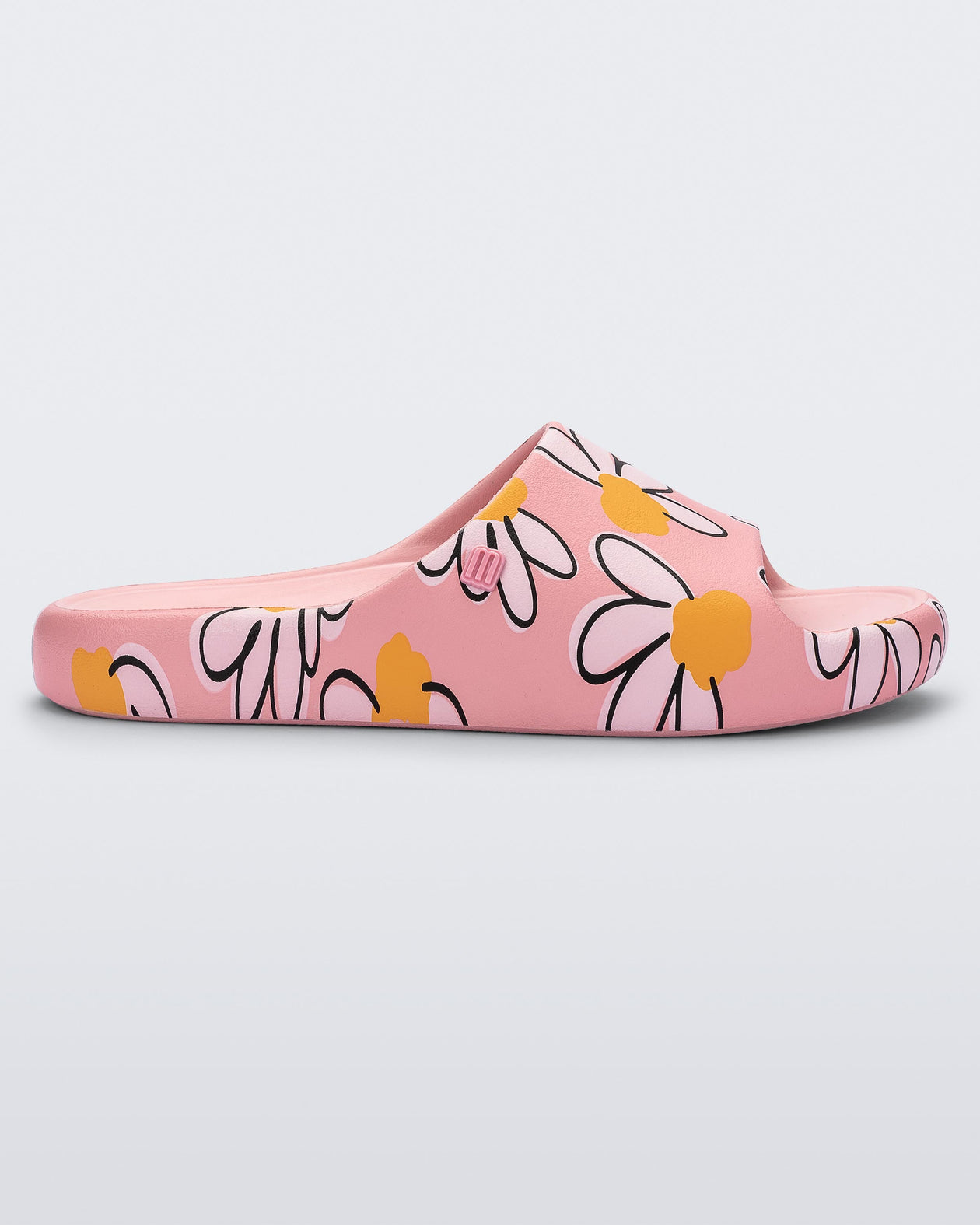 Side view of a pink Free Print slide with daisy print flowers