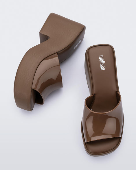 Side and top view of a pair of brown Posh platform heels