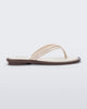 Side view of a beige Wave Flip Flop with small heel and brown sole