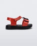 Side view of a red/black Mini Melissa Jump sandal with a black Mickey Mouse logo detail on the front red strap and a red ankle strap