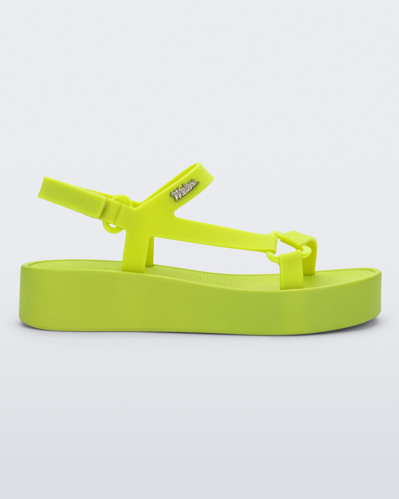 Side view of a green Sun Downtown Platform sandal.
