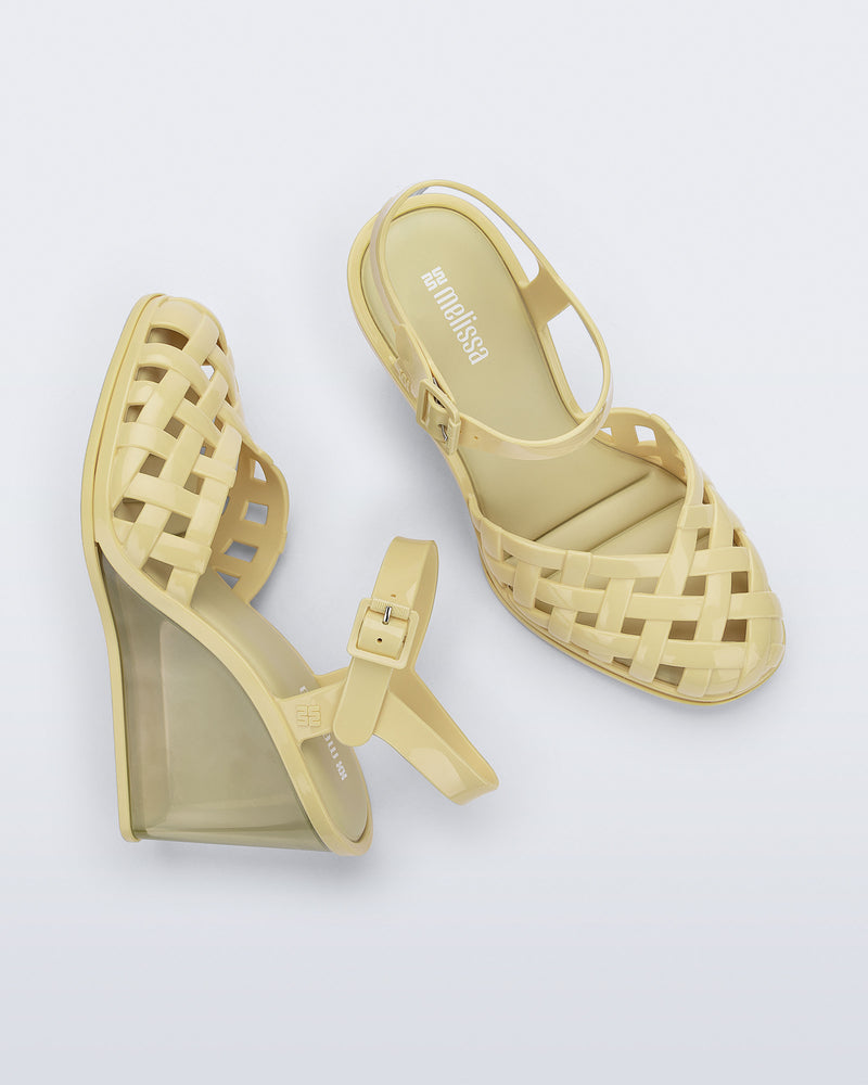 Side and top view of a pair of creamy yellow Agata wedge heel sandals with ankle strap