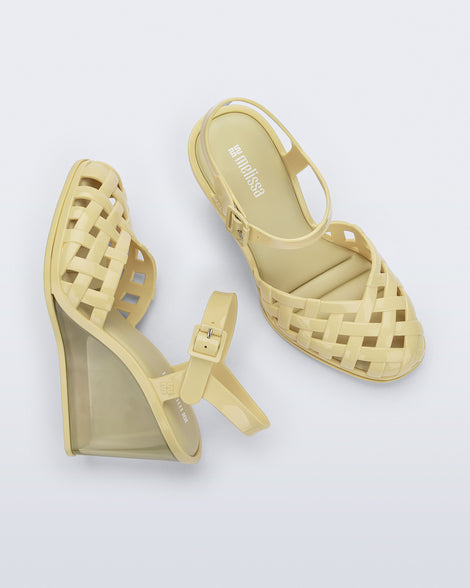 Side and top view of a pair of creamy yellow Agata wedge heel sandals with ankle strap