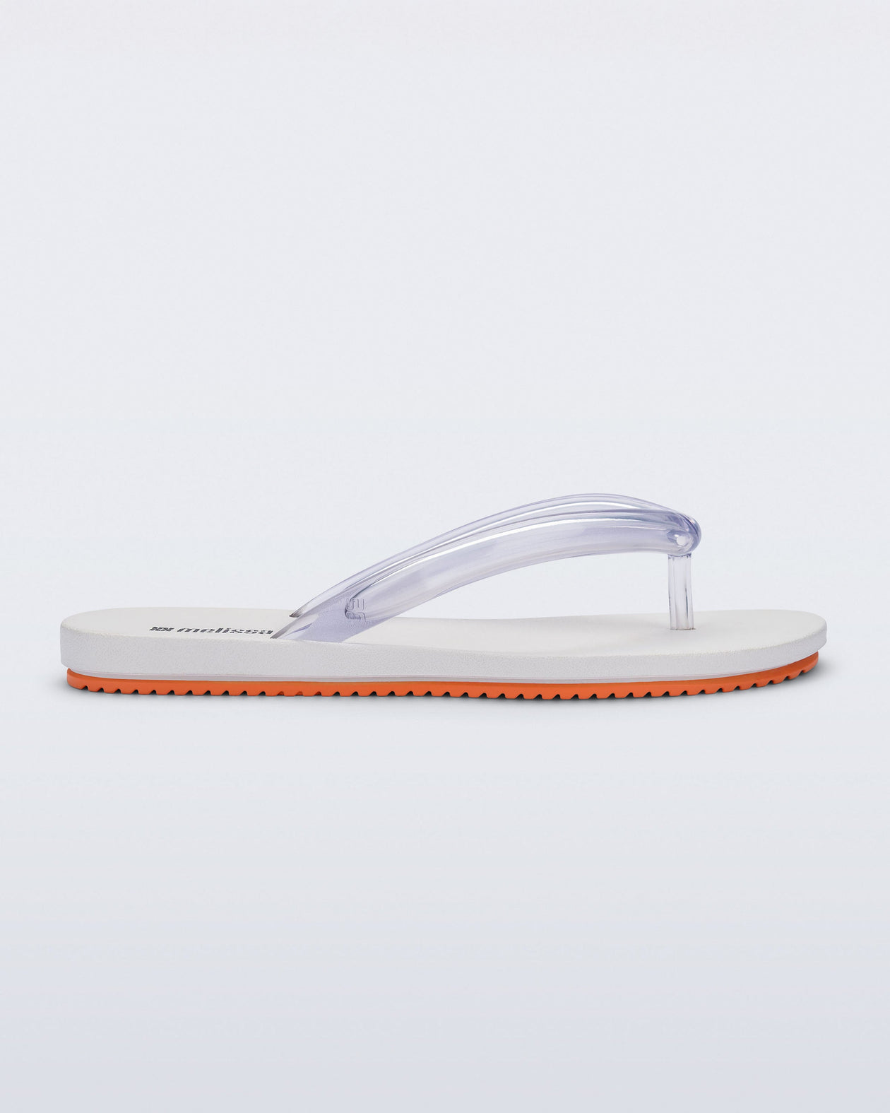 Side view of a white Flip Flop Airflow sandal with a clear strap and orange bottom