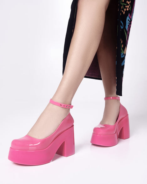 Model's legs wearing a pair of pink Doll Heel women's platform shoes.