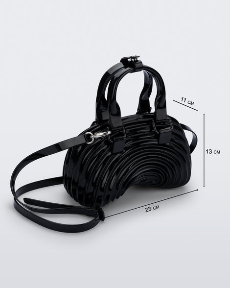 Angled view of a black Quantum Dome + Diesel bag with hand strap and shoulder strap with dimensions 23 cm x 11 cm x 13 cm