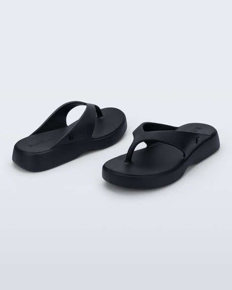 Angled view of a pair of black Free Thong Low Flip Flops
