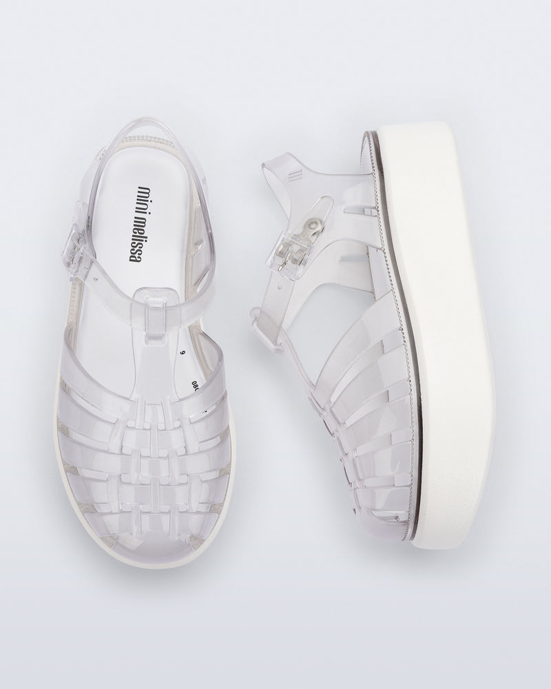 Top and side view of a pair of clear Possession Platform kids fisherman sandals with white soles