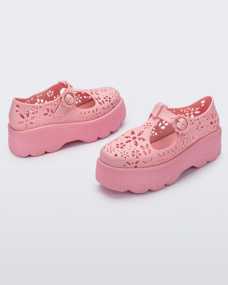 Angled view of a pair of pink Kick Off Lace women's platform shoe with buckle.